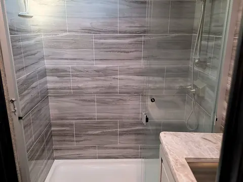 Bathroom with walk-in shower and glass door