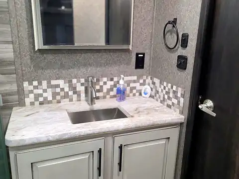 Bathroom vanity with sink and mirror